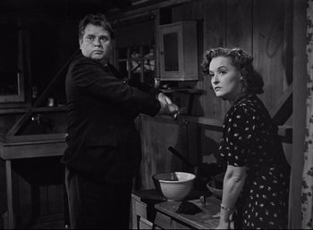 Movie still from “The Southerner” (1945), directed by Jean Renoir – A man and a woman are in a kitchen preparing a meal; Medium shot, Low angle