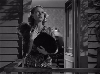 Movie still from “The Southerner” (1945), directed by Jean Renoir – A black and white photo of a woman holding a cat; Medium shot, Low angle