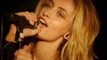 Movie still from “The Space Between” (2021), directed by Rachel Winter – A beautiful young blond haired woman brushing her teeth; Close Up shot, Low angle