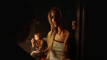 Movie still from “The Space Between” (2021), directed by Rachel Winter – A woman sitting in a room next to another woman; Medium shot, Over the shoulder angle