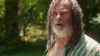 Movie still from “The Space Between” (2021), directed by Rachel Winter – An old man with long hair and a beard; Close Up shot, Over the shoulder angle