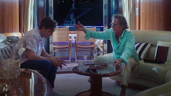 Movie still from “The Space Between” (2021), directed by Rachel Winter – Two men sitting in a room talking to each other; Medium shot, Over the shoulder angle