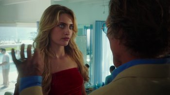 Movie still from “The Space Between” (2021), directed by Rachel Winter – A woman in a strapless dress looking at a man in a suit; Close Up shot, Over the shoulder angle