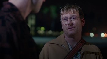 Movie still from “The Space Between” (2021), directed by Rachel Winter – A man wearing glasses is talking to another man; Close Up shot, Over the shoulder angle