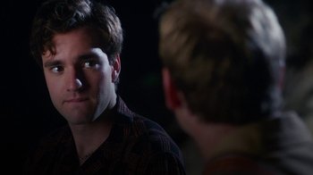 Movie still from “The Space Between” (2021), directed by Rachel Winter – A man looking into a mirror while another man looks at him; Close Up shot, Over the shoulder angle