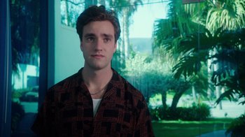 Movie still from “The Space Between” (2021), directed by Rachel Winter – A young man wearing a brown and black checkered shirt; Medium shot, Over the shoulder angle