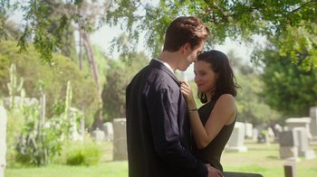 Movie still from “The Space Between” (2021), directed by Rachel Winter – A man and a woman standing next to each other in a cemetery; Medium shot, Over the shoulder angle
