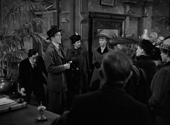 Movie still from “The Spiral Staircase” (1946), directed by Robert Siodmak – A black and white photo of a group of people; Medium shot, Over the shoulder angle
