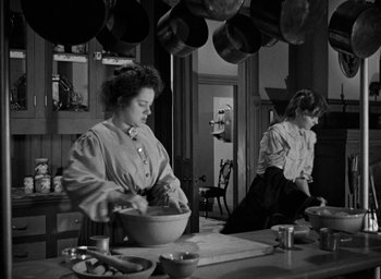 Movie still from “The Spiral Staircase” (1946), directed by Robert Siodmak – Two women are in a kitchen preparing food for dinner; Medium shot, Low angle
