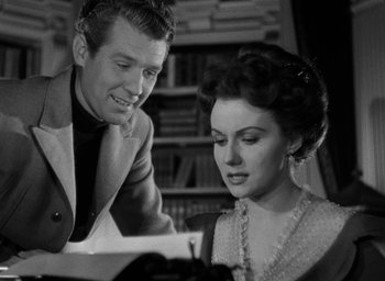 Movie still from “The Spiral Staircase” (1946), directed by Robert Siodmak – A man and a woman are looking at a piece of paper; Medium shot, Over the shoulder angle