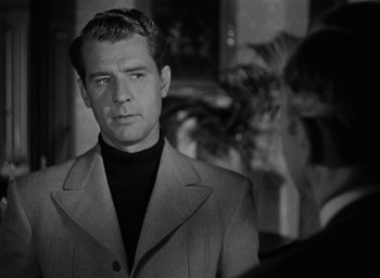 Movie still from “The Spiral Staircase” (1946), directed by Robert Siodmak – Black and white photograph of a man wearing a suit; Close Up shot, Over the shoulder angle