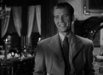Movie still from “The Spiral Staircase” (1946), directed by Robert Siodmak – Black and white photograph of a man wearing a suit and tie; Close Up shot, Low angle