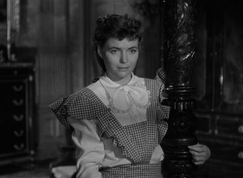 Movie still from “The Spiral Staircase” (1946), directed by Robert Siodmak – An old photo of a woman holding a lamp post; Close Up shot, High angle