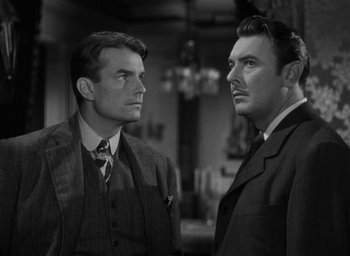 Movie still from “The Spiral Staircase” (1946), directed by Robert Siodmak – Two men standing next to each other in a room; Close Up shot, Low angle