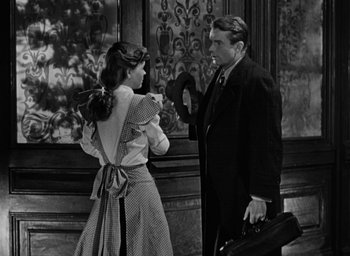 Movie still from “The Spiral Staircase” (1946), directed by Robert Siodmak – A man and a woman standing next to each other; Medium shot, Low angle