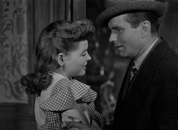 Movie still from “The Spiral Staircase” (1946), directed by Robert Siodmak – A man and a woman standing next to each other; Close Up shot, High angle