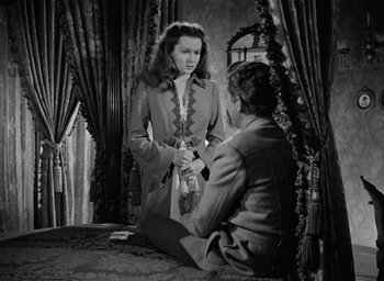 Movie still from “The Spiral Staircase” (1946), directed by Robert Siodmak – Two people sitting on the ground in front of a mirror; Medium shot, High angle