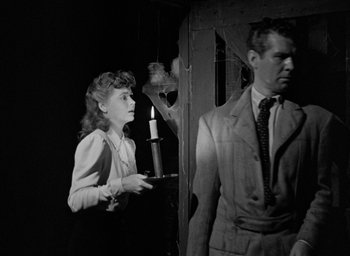 Movie still from “The Spiral Staircase” (1946), directed by Robert Siodmak – A woman and a man standing next to each other in a room; Medium shot, Low angle