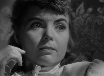 Movie still from “The Spiral Staircase” (1946), directed by Robert Siodmak – An old photo of an older woman looking at the camera; Close Up shot, Low angle