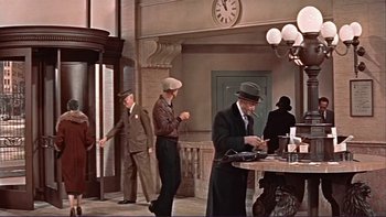 Movie still from “The Spirit of St. Louis” (1957), directed by Billy Wilder – A group of men standing around a table with drinks; Wide shot, Low angle