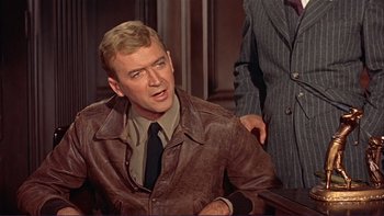 Movie still from “The Spirit of St. Louis” (1957), directed by Billy Wilder – A person wearing a suit and tie; Medium shot, Over the shoulder angle