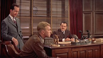 Movie still from “The Spirit of St. Louis” (1957), directed by Billy Wilder – Two men sitting at a table in a room; Wide shot, Over the shoulder angle