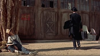 Movie still from “The Spirit of St. Louis” (1957), directed by Billy Wilder – A man in a black suit and a black hat; Wide shot, Low angle