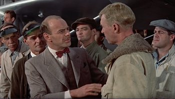 Movie still from “The Spirit of St. Louis” (1957), directed by Billy Wilder – A man in a suit talking to another man in a suit; Medium shot, Over the shoulder angle