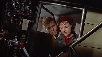 Movie still from “The Spirit of St. Louis” (1957), directed by Billy Wilder – A man and a woman looking at each other through a window of an airplane; Close Up shot, High angle