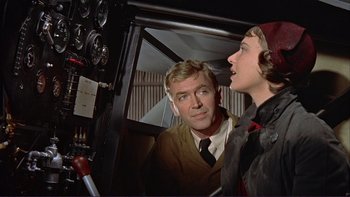 Movie still from “The Spirit of St. Louis” (1957), directed by Billy Wilder – A man and a woman looking at each other in an airplane cockpit; Medium shot, Low angle