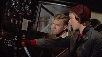 Movie still from “The Spirit of St. Louis” (1957), directed by Billy Wilder – A man and a boy are looking at each other; Medium shot, Low angle