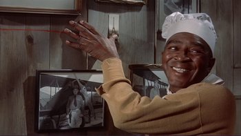 Movie still from “The Spirit of St. Louis” (1957), directed by Billy Wilder – An older man wearing a chef's hat is smiling; Close Up shot, Over the shoulder angle