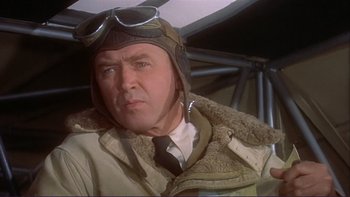 Movie still from “The Spirit of St. Louis” (1957), directed by Billy Wilder – An older man wearing a pilot's jacket and tie; Close Up shot, Low angle