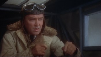 Movie still from “The Spirit of St. Louis” (1957), directed by Billy Wilder – An older man wearing an aviator's jacket and goggles; Close Up shot, Low angle