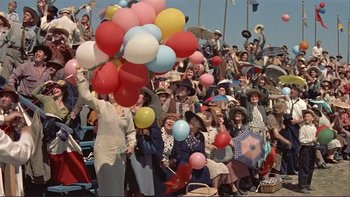 Movie still from “The Spirit of St. Louis” (1957), directed by Billy Wilder – A group of people standing in a crowd with balloons; Extreme Wide shot, High angle