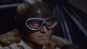 Movie still from “The Spirit of St. Louis” (1957), directed by Billy Wilder – A person wearing a helmet and goggles; Close Up shot, Low angle