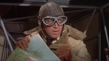 Movie still from “The Spirit of St. Louis” (1957), directed by Billy Wilder – A man in a pilot's outfit holding a map in his hands; Close Up shot, Low angle