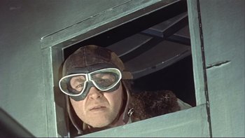 Movie still from “The Spirit of St. Louis” (1957), directed by Billy Wilder – A man wearing goggles and a hat looking out of a window; Close Up shot, Low angle