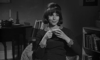 Movie still from “The Spy Who Came in from the Cold” (1965), directed by Martin Ritt – A black and white photo of a woman holding a cup of coffee; Close Up shot, High angle