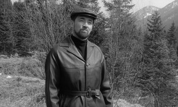 Movie still from “The Spy Who Came in from the Cold” (1965), directed by Martin Ritt – Black and white photograph of a man wearing a leather jacket; Medium shot, Low angle