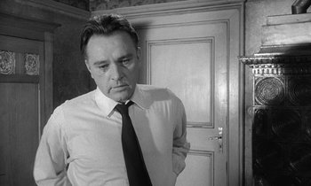 Movie still from “The Spy Who Came in from the Cold” (1965), directed by Martin Ritt – Black and white photograph of a man wearing a tie; Close Up shot, Low angle