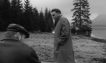 Movie still from “The Spy Who Came in from the Cold” (1965), directed by Martin Ritt – A black and white photo of a man in a trench coat; Wide shot, High angle