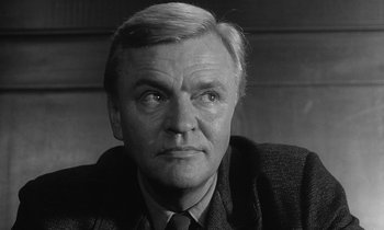 Movie still from “The Spy Who Came in from the Cold” (1965), directed by Martin Ritt – An older man wearing a suit and tie; Close Up shot, Low angle