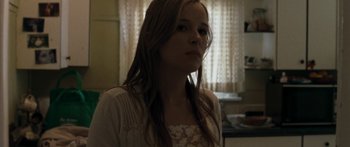 Movie still from “The Square” (2008), directed by Nash Edgerton – A young girl is standing in front of a window; Close Up shot, Low angle