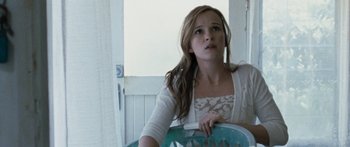 Movie still from “The Square” (2008), directed by Nash Edgerton – A woman sitting in a chair looking up at the sky; Close Up shot, Low angle