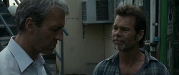Movie still from “The Square” (2008), directed by Nash Edgerton – Two men standing next to each other in front of an air conditioner unit; Close Up shot, Over the shoulder angle