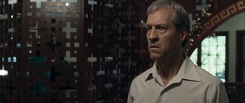 Movie still from “The Square” (2008), directed by Nash Edgerton – A person standing in a room; Close Up shot, Over the shoulder angle