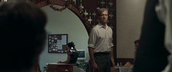 Movie still from “The Square” (2008), directed by Nash Edgerton – A man standing in front of a mirror in a room; Medium shot, Over the shoulder angle