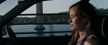 Movie still from “The Square” (2008), directed by Nash Edgerton – A woman sitting in the back seat of a car looking out the window; Close Up shot, High angle