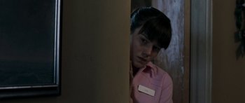 Movie still from “The Square” (2008), directed by Nash Edgerton – A woman in a pink shirt is standing by a wall; Close Up shot, Low angle
